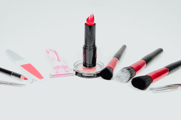 Set of woman make up cosmetics on white background. Beauty and fashion concept. On table lies...