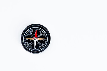 A magnetical compass on a white table.