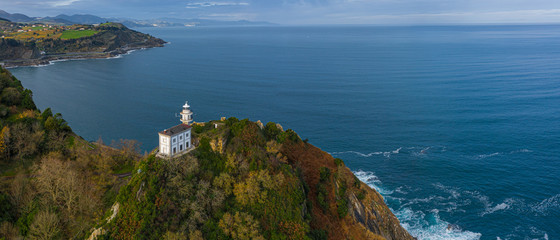 Getaria lighthouse in Gipuzkoa, Basque country - drone aerial view 21:9