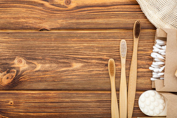 Zero waste home product. Bamboo toothbrushes, soap, Cotton Swabs Wooden Sticks on wooden background. Natural bath products. Flat lay with copy space.Eco friendly, Zero waste, Plastic free Dental care