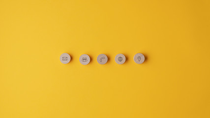 Five wooden cut circles with contact and information icons