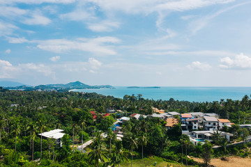 Fototapeta na wymiar Aerial scenery view of white sand shore with turquoise clear sea water. Bird's eye panoramic view of picturesque lagoon with hotels on beach. Populated island in Thailand