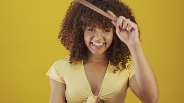 Cooking utensils. Cooking woman in kitchen with frying pan and wooden spoon. Housewife dancing. 4K.