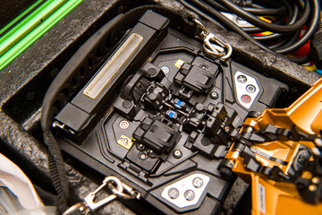 Macro detail of new modern innovative and powerful performance active clad-alignment splicer used for splicing an array of thin optical fiber types - obrazy, fototapety, plakaty