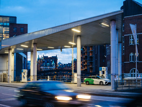 HAMBURG, GERMANY - MAR 21, 2018: CleverShuttle car sharing Driver fueling a hydrogen-powered car Toyota Mirai with GH2 hydrogen in central Hamburg, Germany dusk evening