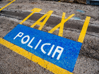 Yellow Taxi and blue Policia parking signs on the asphalt in the spanish city of Palma de Mallorca