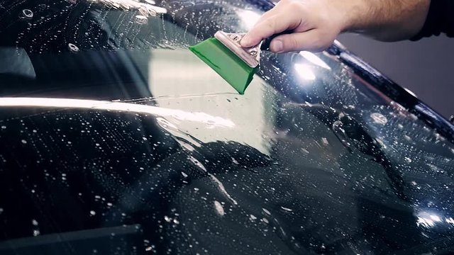 gluing armor on the windshield of the car
