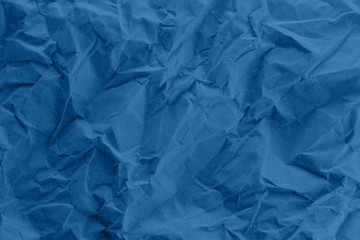 A blue crumpled paper texture.