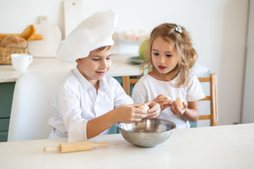 Obraz na płótnie Canvas cute children in the kitchen prepare food at home