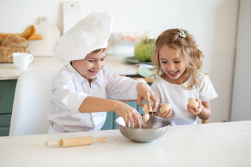 Obraz na płótnie Canvas Kid chefs in the kitchen at home
