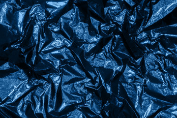 Silver dark shiny texture of a crumpled sheet.
