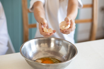 close up of children cooking with eggs