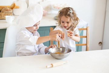 Obraz na płótnie Canvas cute children enjoying in the kitchen prepare food