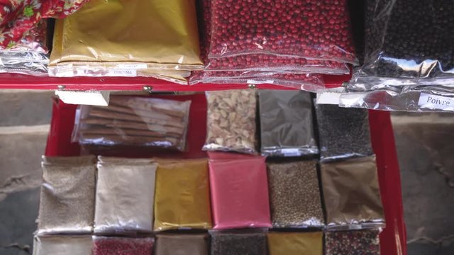 Various types of pepper and other local herbs / spices in small plastic bags on display at tourist market - Antananarivo, Madagascar