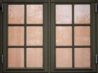 Fototapeta premium Old vintage wooden windows with 12 frames. Outside view and light inside. Close up image.