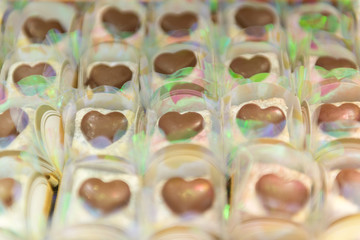 Close up of heart shaped romantic white chocolate. selection of gourmet handmade chocolates. Sweets for Valentine's Day or Wedding Party. Symbolic of love. Selective focus.