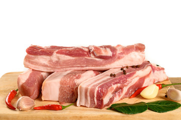 Streaky pork on cutting board isolated on white background.