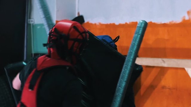 Knights training - Two men having a training fight in the gym using a safe sword and shield