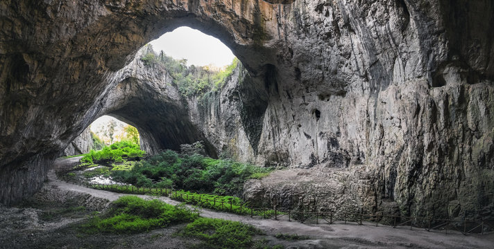 Devetashka cave interior, near Lovech town, Bulgaria. Tunnel of the cave with holes on the top