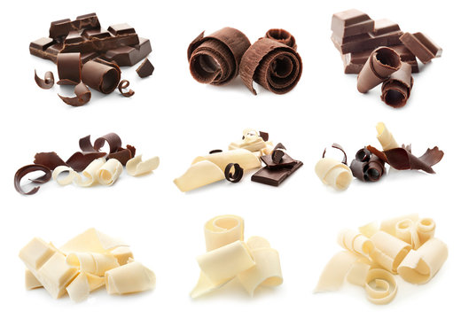 Pieces of different chocolate with curls on white background
