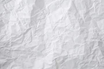 white and gray crumpled paper texture background. crush paper so that it becomes creased and wrinkled.