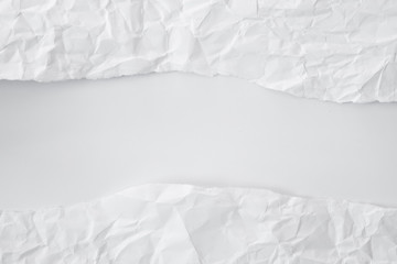 white and gray crumpled paper texture background. crush paper so that it becomes creased and wrinkled.