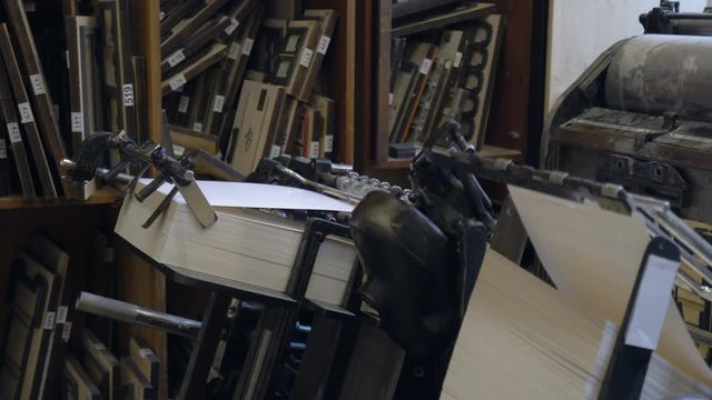 Printed sheets of paper are served in the printing press