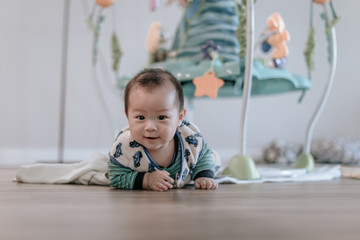 Asian baby boy doing tummy time at home