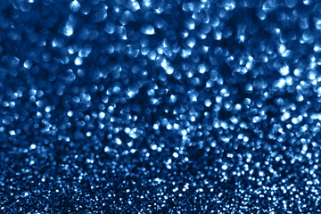 Glamour blue sparkling background. Blured glitter background with blinking stars. Holiday abstract texture.