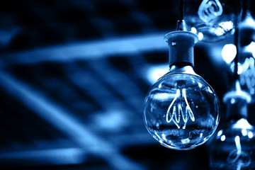 Group of blue lamps with interesting shape of tungsten filament.