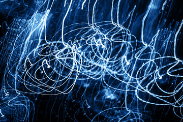 Street lights in speeding car, light motion with slow speed shutter. Classic blue color of the year...