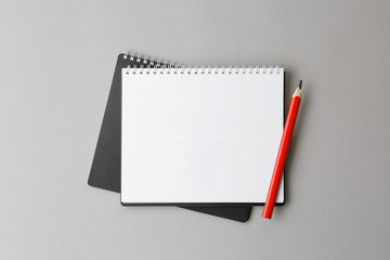 notebook with pencil on a gray background