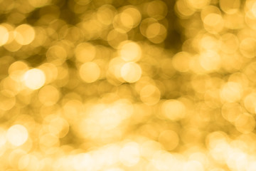 Abstract bokeh background, blurred light on gold