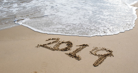 Number 2019 on sandy beach for new year concept