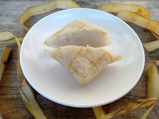 Ketupat or Rice Dumpling On Wooden Background. Ketupat is a natural rice casing made from young coconut leaves for cooking rice during eid Mubarak, Idul Fitri or Aidilfitri