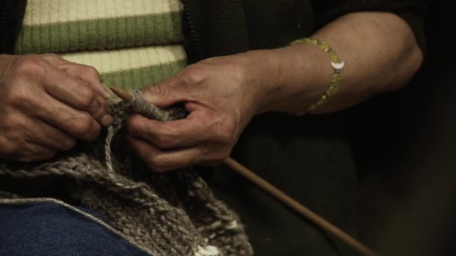 Hands of a Woman Knitting a Sweater. Close-Up..