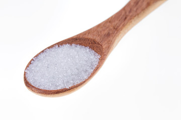 Fototapeta na wymiar Spoon full of granulated sugar on a white background