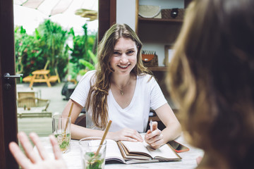 Charming young female smiling while looking at camera