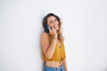 Fototapeta premium Relaxed woman laughing and speaking on smartphone