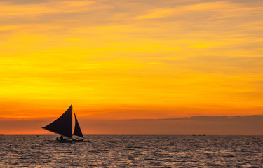 Fototapeta na wymiar sailing boat at sunset. orange sky. boat on a sunset background. sailboat on a sunset background. beautiful sunset. unusual sky