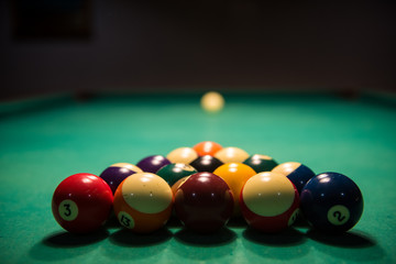 Billiards table with balls and cue ball set up for break