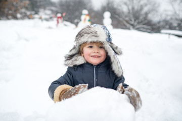 Fototapeta na wymiar Happy kid winter portrait. Kids in snow. Merry Christmas and Happy new year. Winter kid. Winter morning. Winter emotion.
