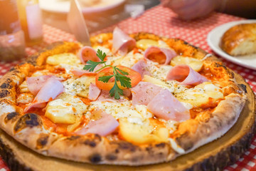 Pizza served on wooden tray / Homemade pizza cheese with ham on the dining table food italian cuisine