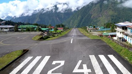 4K UHD Footage of twin-engine short-range plane landing at the runway of world's most dangerous airport in Lukla,Nepal. Tenzing–Hillary Airport at altitude 2,845 m
