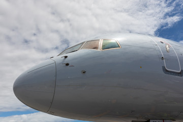 The nose of a plane against the sky
