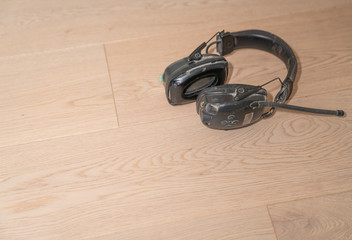 Old headphones dropped by trademan on new floor.