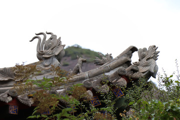 Obraz premium Architectural details of the roof at Tianshui Wushan Water Curtain Caves, Gansu China. OR Temple roof details at the Water Curtain Caves in Wushan , Gansu, China.