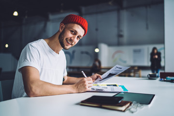 Content handsome male working with papers