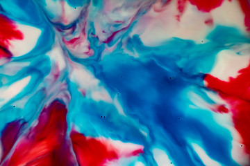 Red and Blue Graphic Explosion. Splatters, cells and splashes of color. A fantasy universe. Hidden images. Paint and ink art on a milky background. Dream images.
