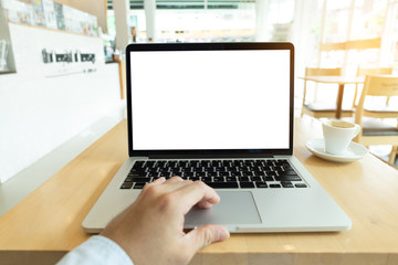 mockup image blank screen computer with blank white background for advertising text,hand man using laptop contact business search information on desk at home office.marketing and creative design